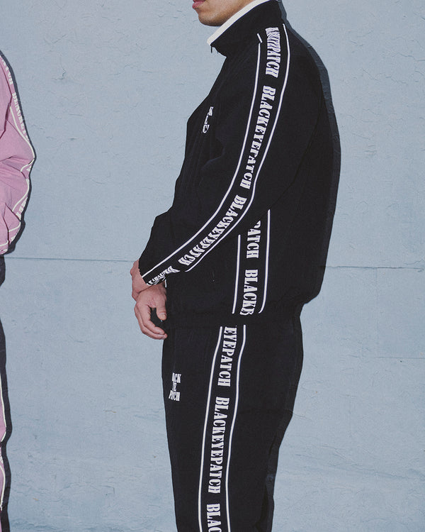 REFLECTIVE STENCIL LOGO TRACK PANTS BLACK